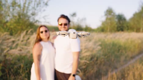 couple kissing with drone flying in the background