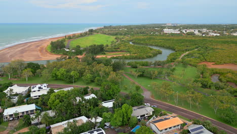 aerial drone of rapid creek casuarina drive traffic along beachfront by river estuary, nt australia