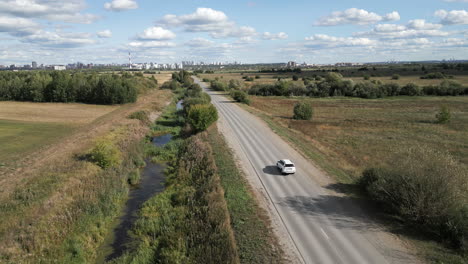 country road leading to cityscape