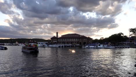 boats near a pier on a cloudy evening during sunset, no persons