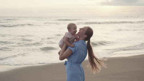 young mother and toddler by sea