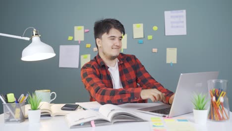 male student chatting with beloved on laptop.