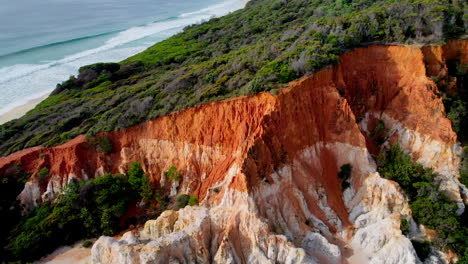 close-up drone shot of the striking white and orange cliffs of the pinnacle in beowa national park, nsw. detailed,