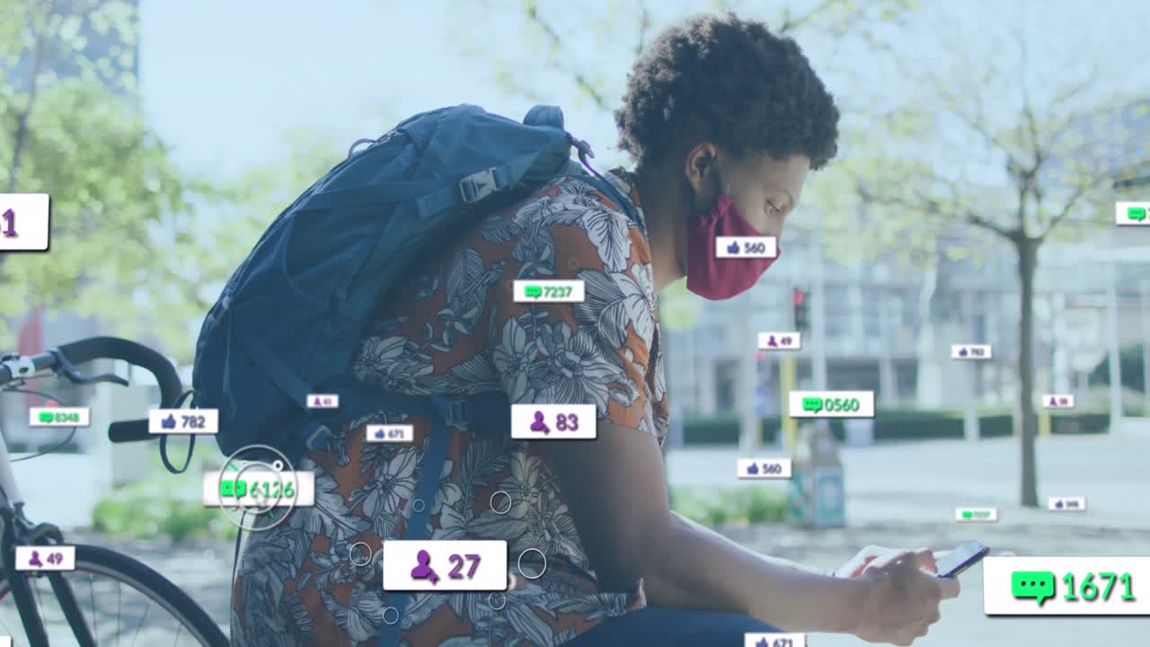 Animation of social media icons over african american woman with face mask using smartphone