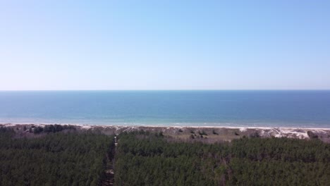 aerial baltic sea flyby shot in curonian spit national park, lithuania