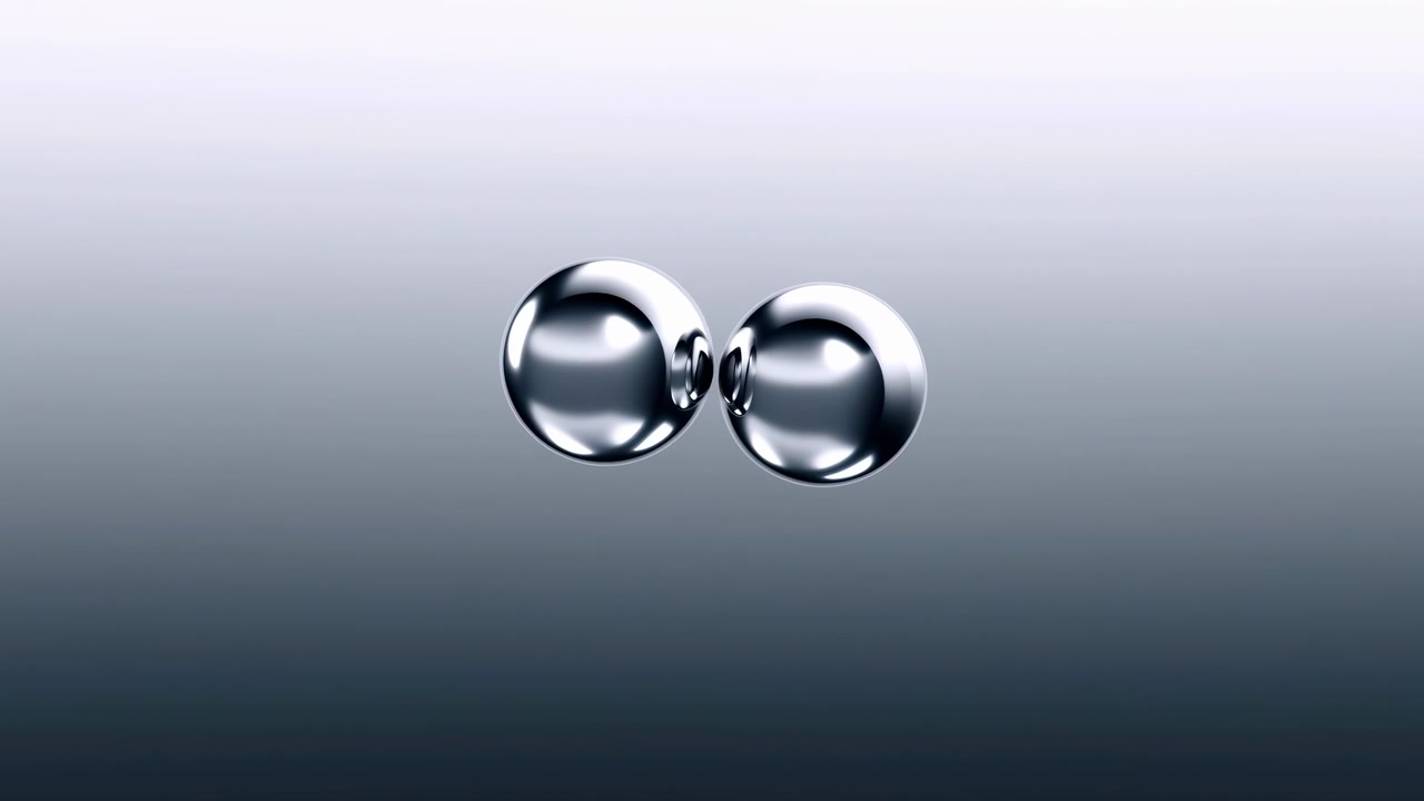 Due goccioline metalliche riflettenti fluttuano vicino al centro superiore di uno sfondo sfumato liscio dal grigio al scuro, creando una composizione astratta pulita e minimale