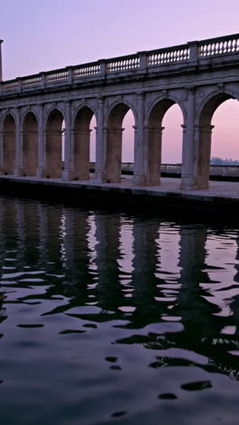 stone arch bridge reflection at sunset