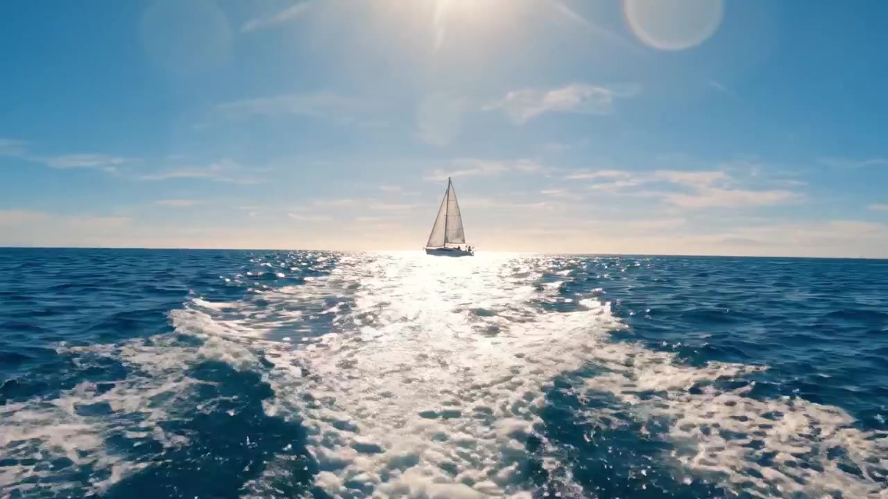 A Serene Sailing Journey Across Sparkling Waters Under a Bright Sun with a Single Sailing Boat Creating Tranquil Ripples in the Open Sea