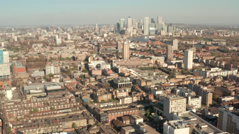 slow aerial shot over whitechapel towards canary wharf skyscrapers
