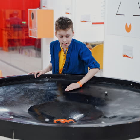 boy in the museum science. a planet swallowed by black hole simulation, endless gravity