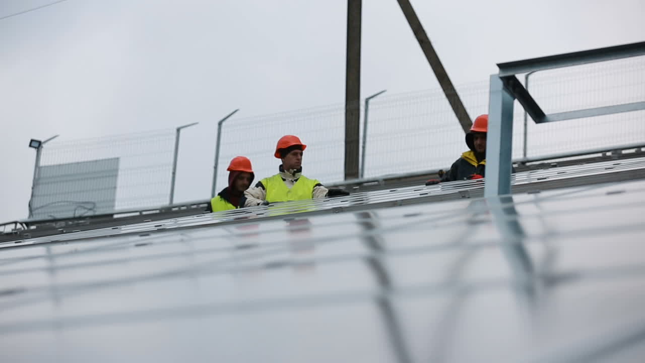 Technician installing solar panels. VINNITSA, UKRAINE - NOVEMBER 2017: Solar panel and professional worker installing photovoltaic solar panels