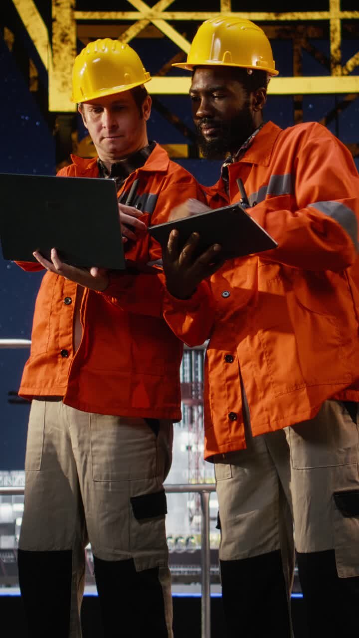 Vertical Video Environmental officers on marine oil platform communicate via radio