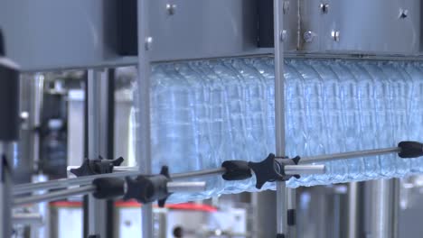 new plastic bottles on the conveyor belt of a drinking water plant