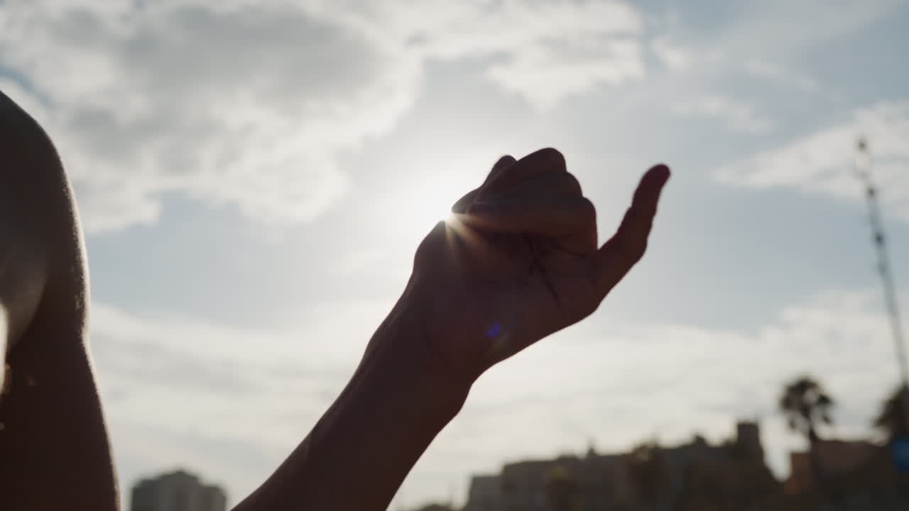 Surfer man walking to the beach at sunset preparing for surfing training and search for waves in Barcelona, spain, water, ocean exercise in sea with board, athletic male holiday or travel in vacation