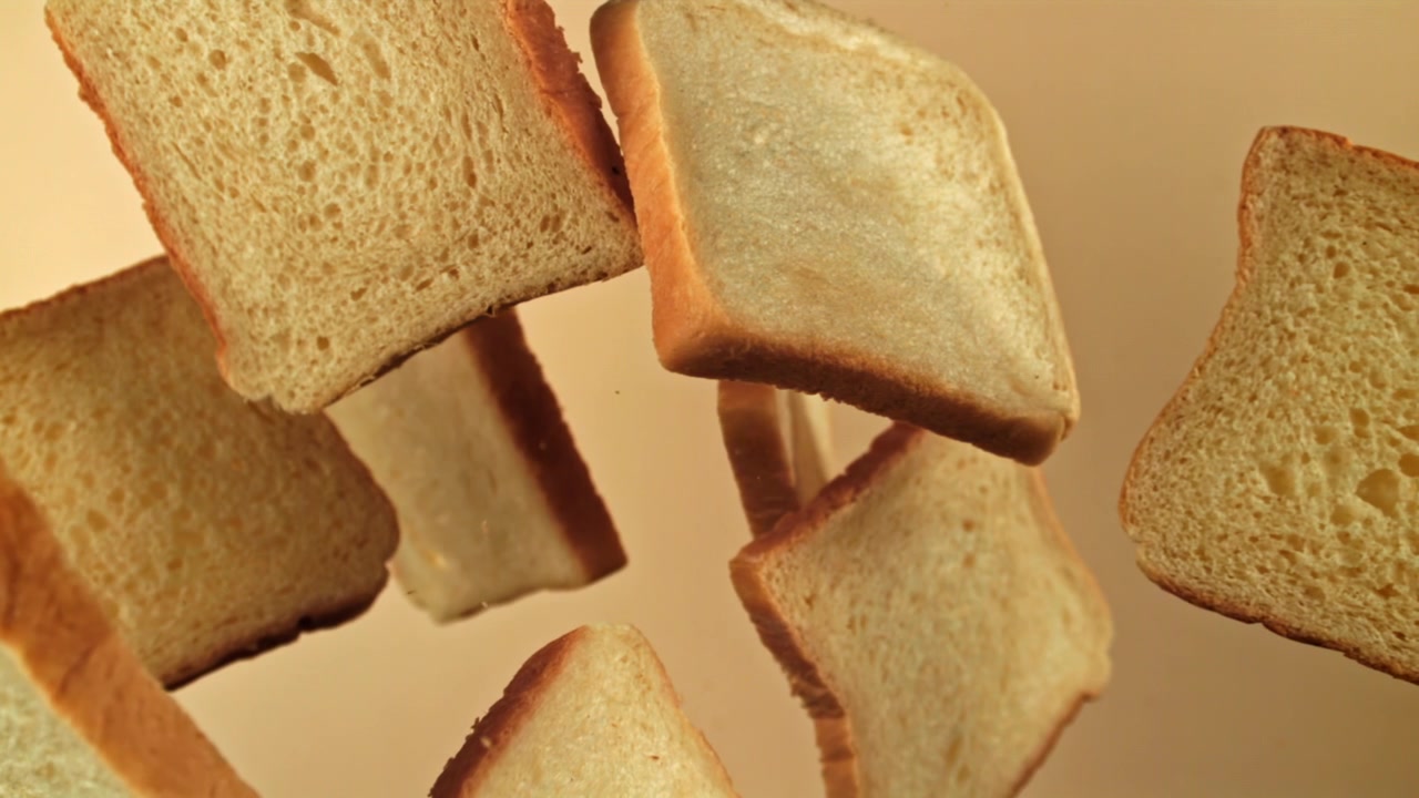 White Bread Slices Falling in Slow Motion