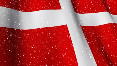 danish flag waving during snowfall