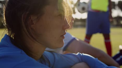 Female-soccer-player-sitting-on-soccer-field.-4k