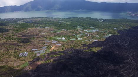 aerial view of lava field near agricultural land in the rural town of batur, bali indonesia