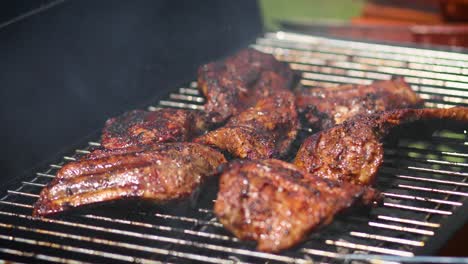 Tasty-ribs-cooking-on-barbecue-grill-for-summer-outdoor-party