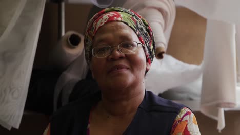 mixed race woman working at a hat factory