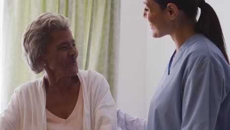 nurse helping a senior woman in a retirement home