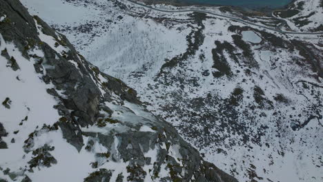 View-From-The-Top-Of-Steep-Snowy-Mountain-Cliff-In-Grotfjord,-Kvaloya,-Northern-Norway