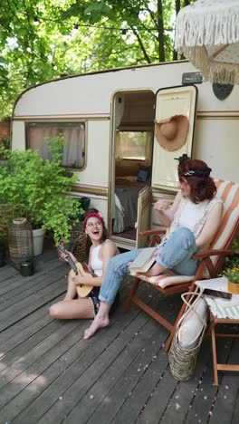 friends enjoying a summer day by a campervan