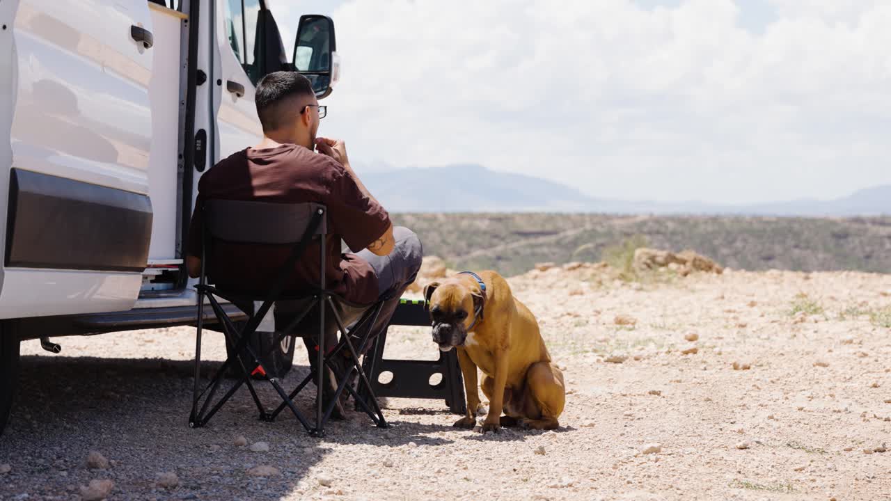 Man training his boxer dog in the desert near gorafe, spain