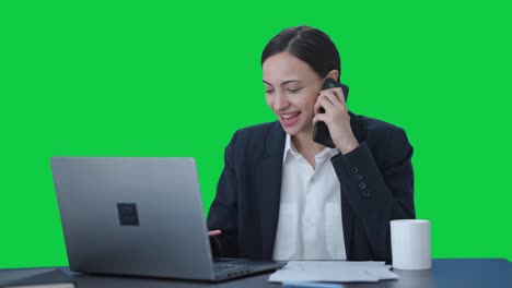 Happy-Indian-female-manager-talking-to-someone-on-mobile-phone-Green-screen