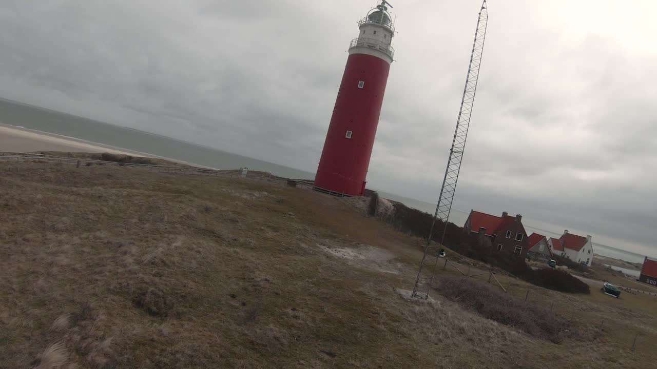 Eierland Lighthouse On Grass-topped Dunes At The Village In Coast Of Texel Island In North Holland, Netherlands. - Drone, POV FPV