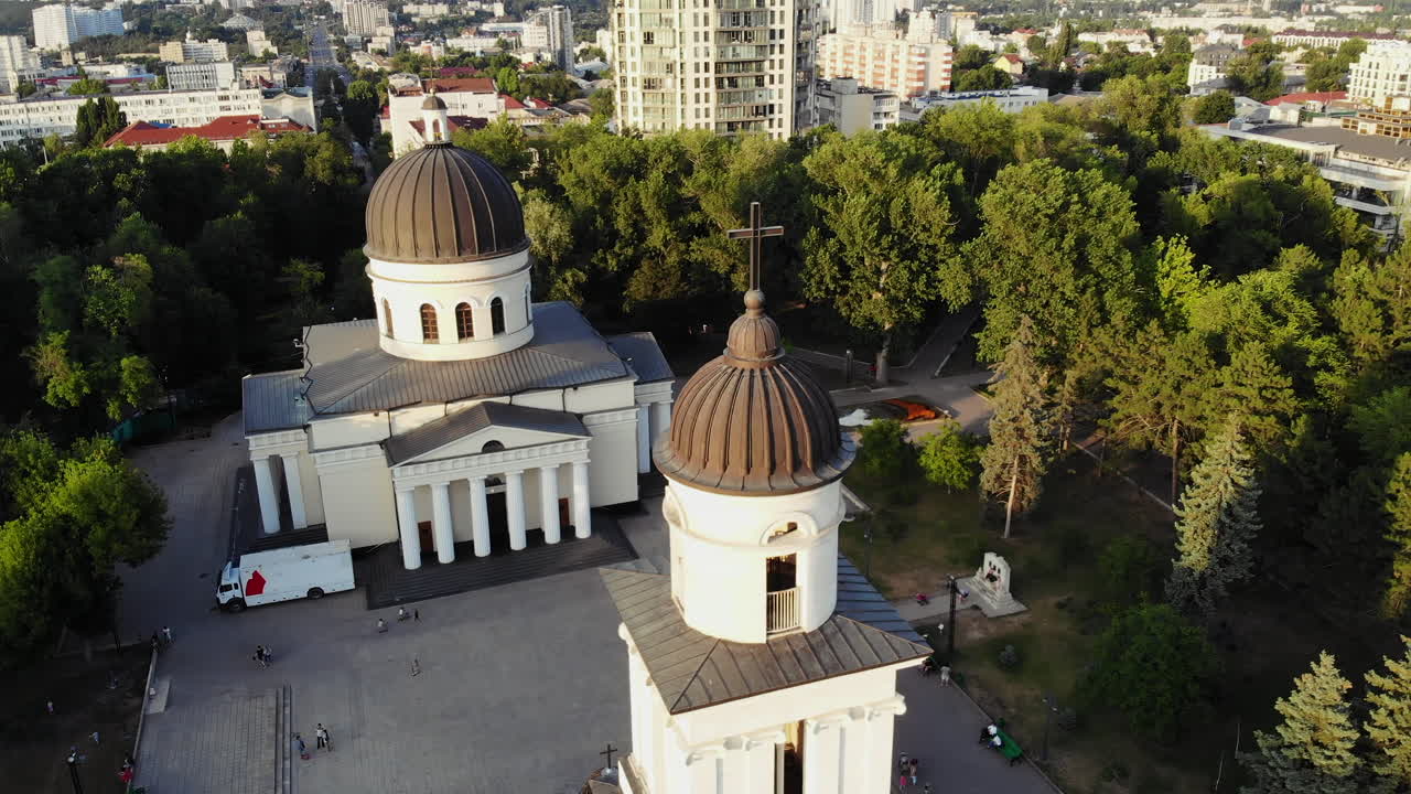 Chisinau, Moldova - June 14, 2021: Aerial drone view showing the Nativity Cathedral and bell tower surrounded by trees and city buildings in Chisinau, Moldova