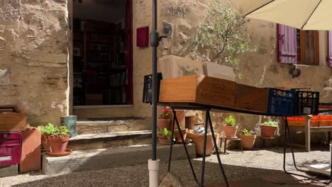 books displayed outside the entrance of a tawny stone house bookstore