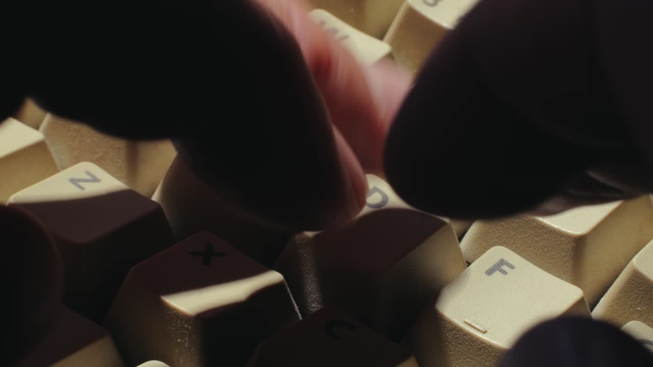 Man working and gaming on retro computer PC, IT engineer with vintage computer at home, using old fashion technology, close up of retro setup.