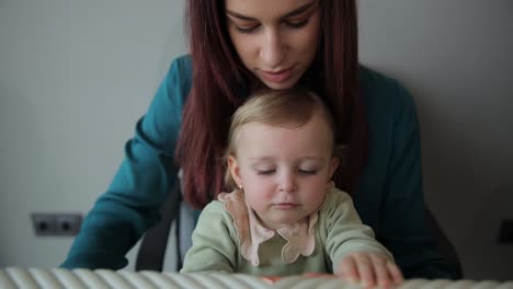 a woman with a small child is packing a suitcase for a trip. travel concept. vertical video