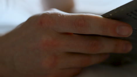 hands holding a book while reading_close-up