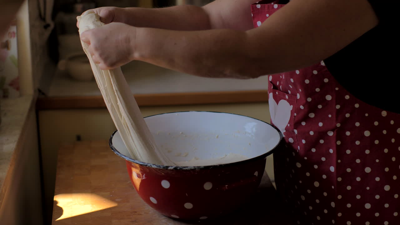 Woman Kneading Dough in Kitchen