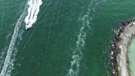 mini speed boat creating a white wake trail