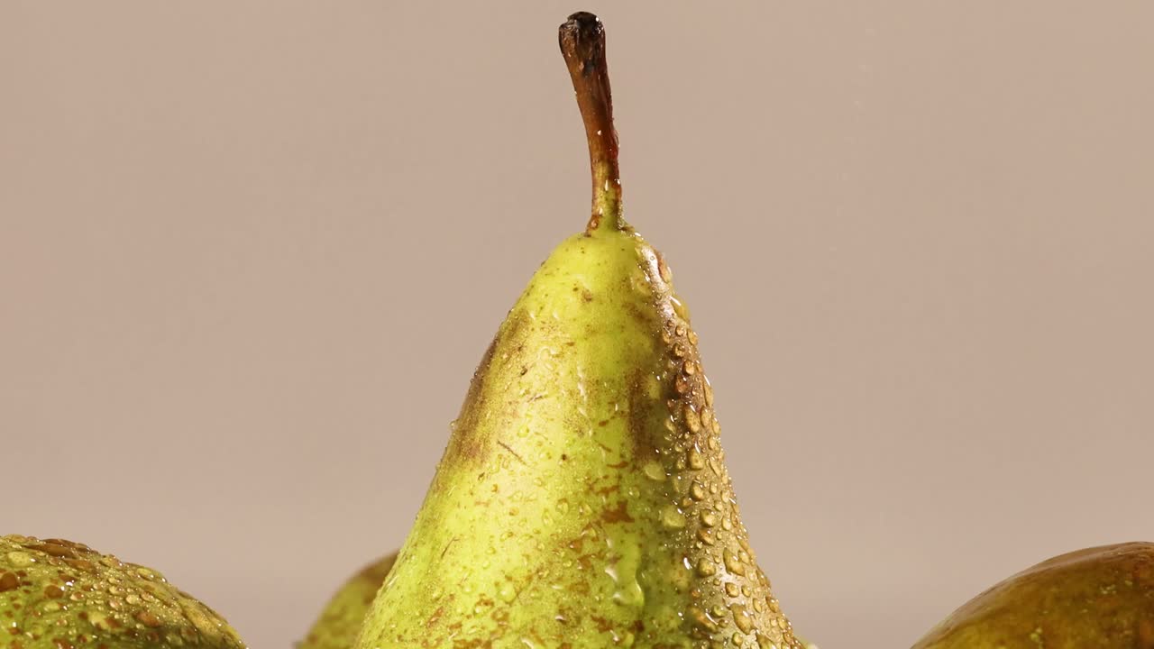 Detail shot of water spraying on the top of a pear