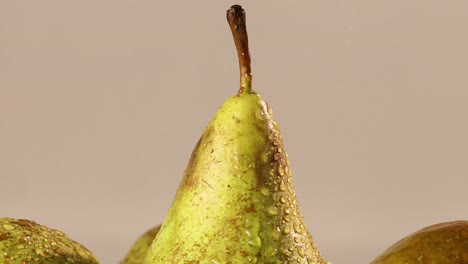 detail shot of water spraying on the top of a pear