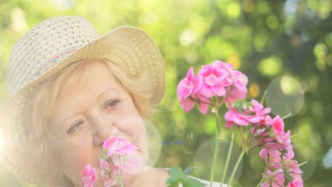 Animación-De-Puntos-De-Luz-Sobre-Una-Mujer-Caucásica-Mayor-En-El-Jardín