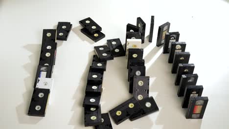 Domino,-stacked-and-tumbling-VHS-tapes