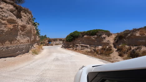 winding road between stone walls on a greek
