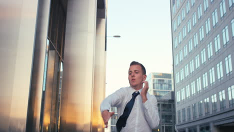 Contemporary-funky-caucasian-businessman-street-dancer-dancing-freestyle-in-the-city