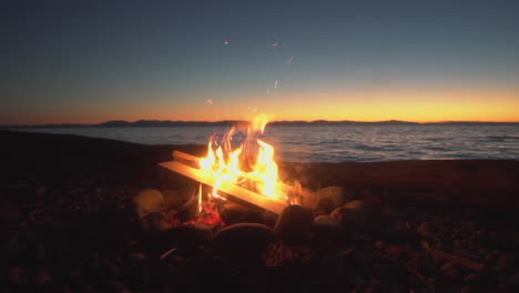 slow-motion: bonfire on a vancouver beach at sunset 4k