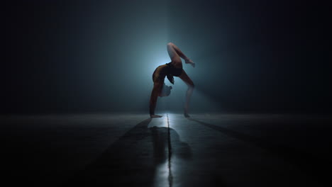 Flexible-gymnast-doing-backbend-exercises.-Beautiful-woman-stretching-indoors.