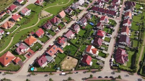 residential area with many single family houses with green gardens in a small town, sunny day, drone, outskirts of the city