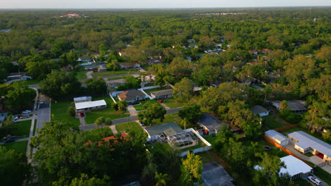 aerial diagonal fly over the streets of a residential suburban neighborhood with dense trees in tampa, florida. aerial drone shot