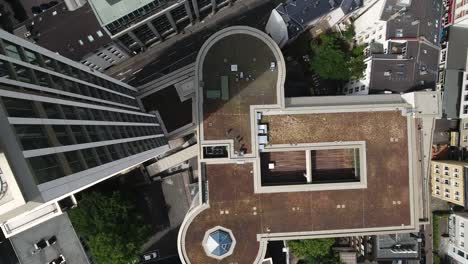 overhead aerial of modern high-rise office building rooftop