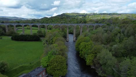 aerial view pontcysyllte aqueduct and river dee canal narrow boat bride in chirk welsh valley countryside rising forward