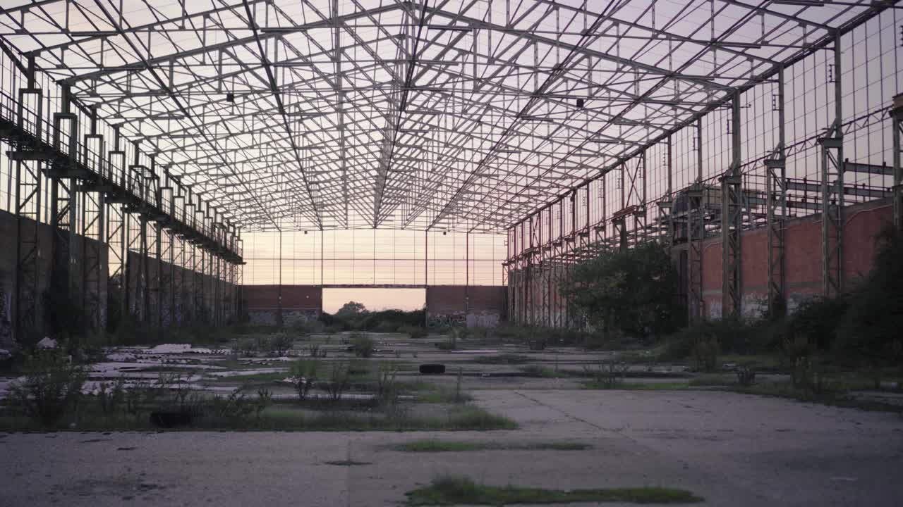 Walking inside an abandoned warehouse at sunset - Point of view golden hour